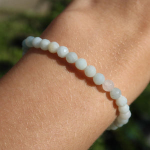 Faceted Amazonite gemstone bracelet in shades of light blue, worn on wrist, showcasing calming and balancing energy properties.