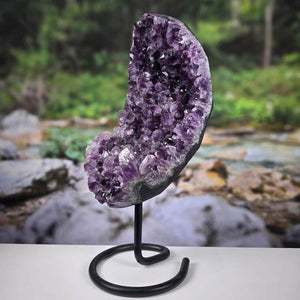 Amethyst Drusen Geode from Uruguay displayed on a metal stand, showcasing deep purple crystals and sparkling texture.