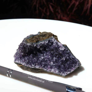 Intricate and sparkling Amethyst Druse from Uruguay, 9x6cm, showcasing deep purple crystals beside a pen, symbolizing harmony and transformation.