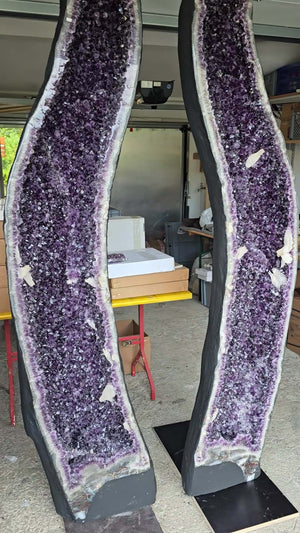 Pair of large XXL Amethyst geodes with intense dark purple crystals on display, ideal for upscale decor settings.
