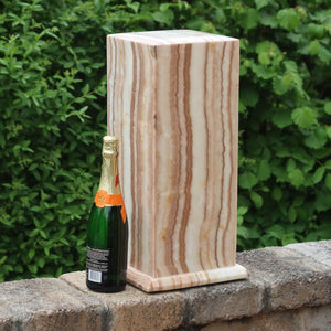 Handmade Aragonit lamp from Morocco with LED, emits warm light. Tall and rectangular, shown beside a champagne bottle for scale.