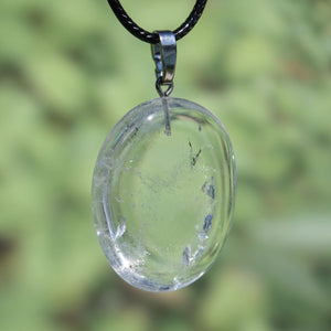 Clear Bergkristall pendant with silver bail, enhances focus and stability, 39mm unique piece, on a black cord, against blurred background.
