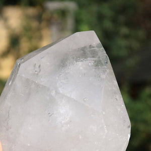 Polished quartz crystal point from Brazil, showcasing natural clarity and sparkling facets, ideal for meditation.