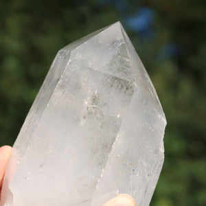 Hand holding a polished Bergkristall quartz crystal point, showcasing its clarity and natural facets, ideal for meditation.