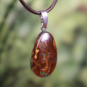 Boulder opal pendant with silver loop, hand-polished, showcasing unique colors and patterns, size 30x17mm.