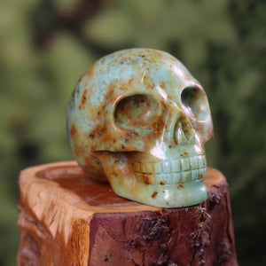 Handcrafted Andean Opal Crystal Skull on wooden stand, 6x6 cm, unique gemstone carving, natural stone artistry.