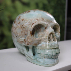 Handcrafted large blue aragonite calcite crystal skull, 14x12 cm, unique collectible from Steinwelten mineral shop.