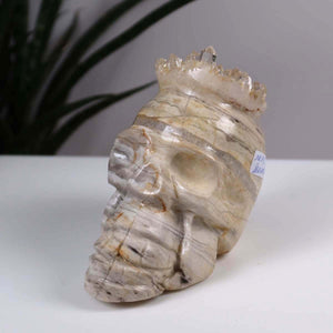 Handcrafted crystal skull made from natural stone with unique crown design, ideal for collectors and crystal enthusiasts.