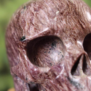 Handcrafted Charoit crystal skull with unique design, an exquisite gemstone collectible for purchase. Ideal for crystal collectors.