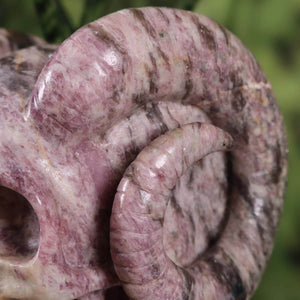 Detail of hand-carved XL Lepidolith crystal skull with pink Tourmaline, showcasing unique craftsmanship; available at Steinwelten.