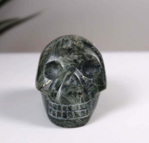 Seraphinite Clinochlore crystal skull, handcrafted collectible piece, unique design, polished gemstone sculpture.