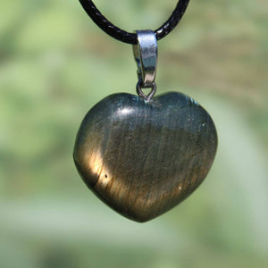 Heart-shaped labradorite pendant showcasing blue, green, and gold hues, symbolizing intuition and spirituality.