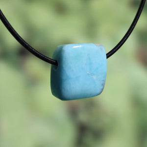 Square Larimar pendant made from unique blue gemstone on black cord, combining natural beauty and stylish design, 20mm size.