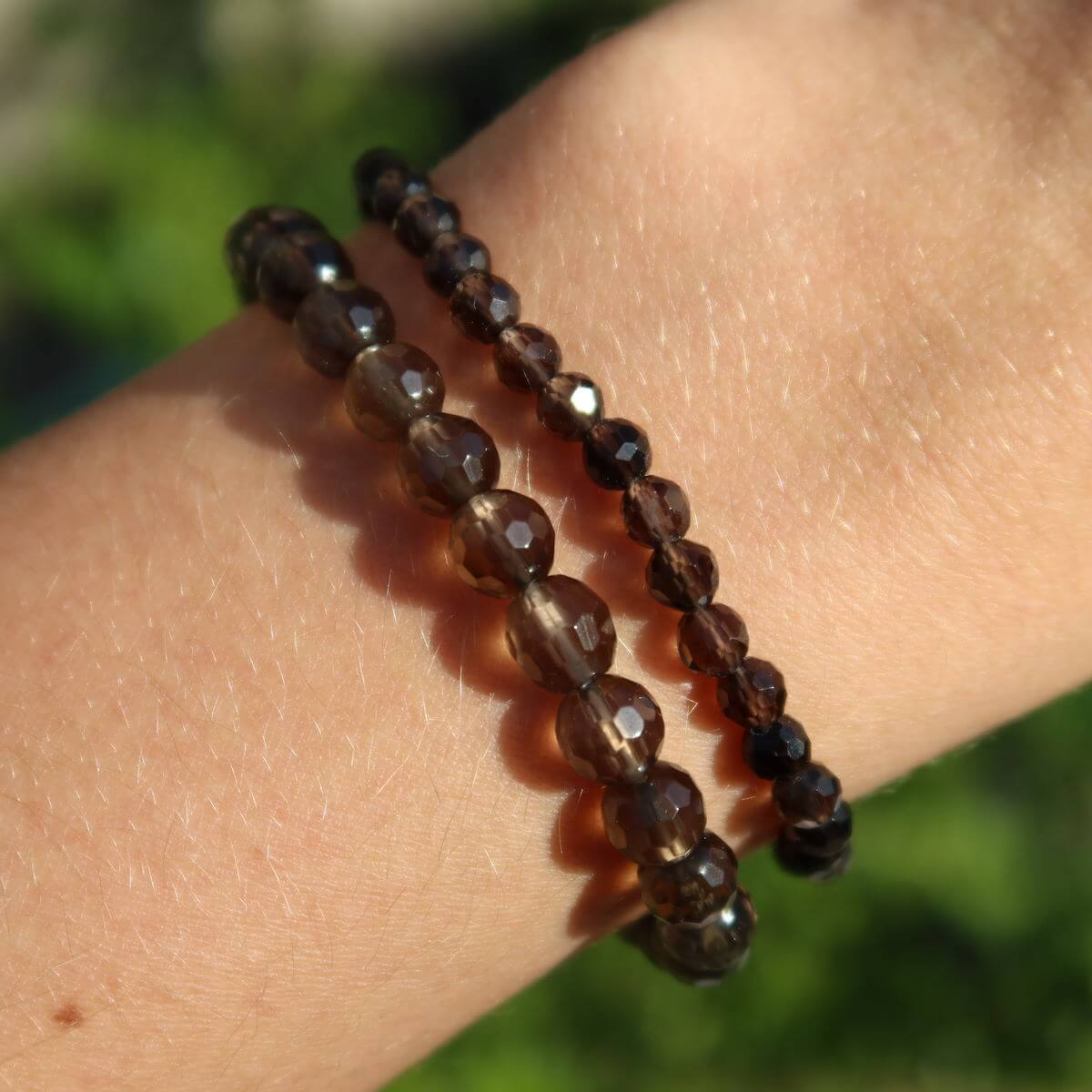 Faceted smoky quartz gemstone bracelet displayed on wrist, featuring natural, earthy beads highlighting the stone's calming properties.