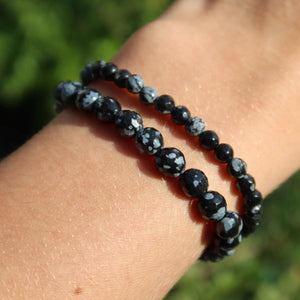 Faceted Snowflake Obsidian Gemstone Bracelet on wrist with unique black and white pattern beads in various sizes 4-6-8mm.