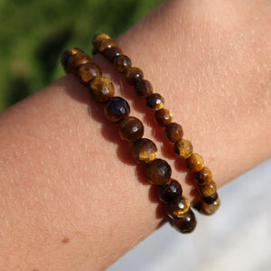 Faceted tiger's eye gemstone bracelets worn on wrist, showcasing 4mm to 8mm beads, ideal for focus and clarity.