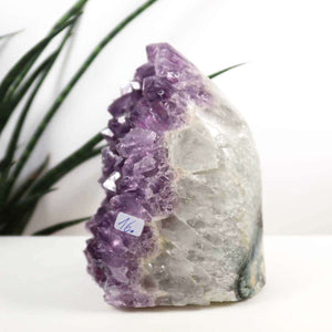 Uruguay Amethyst Mini Geode 10x13cm, extra dark purple crystals for harmony and relaxation, displayed on a white surface.