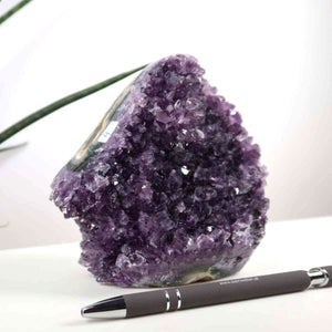 Uruguay Amethyst Mini Geode with deep purple crystals, 11x12cm, for harmony and relaxation, paired with a pen for scale.