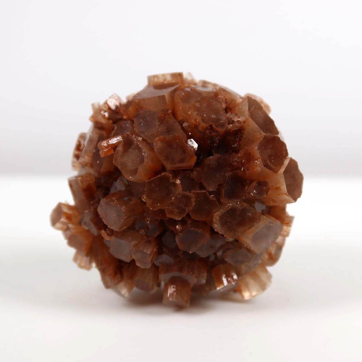 Hand holding natural raw Aragonite crystal cluster from Morocco, 6x6 cm, ideal for collectors and mineral enthusiasts.