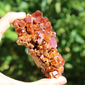 Vanadinit - Natürliche Kristallstufe aus Marokko 8x6x3cm - 0,27kg Nr.44 in der Hand, herausragende rot-orangefarbene Kristalle.