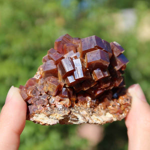 Vanadinit - Natürliche Kristallstufe aus Marokko 6x4,5x4,5cm - 0,19kg Nr.38 in einer Hand, leuchtende rot- bis orangefarbene Kristalle.